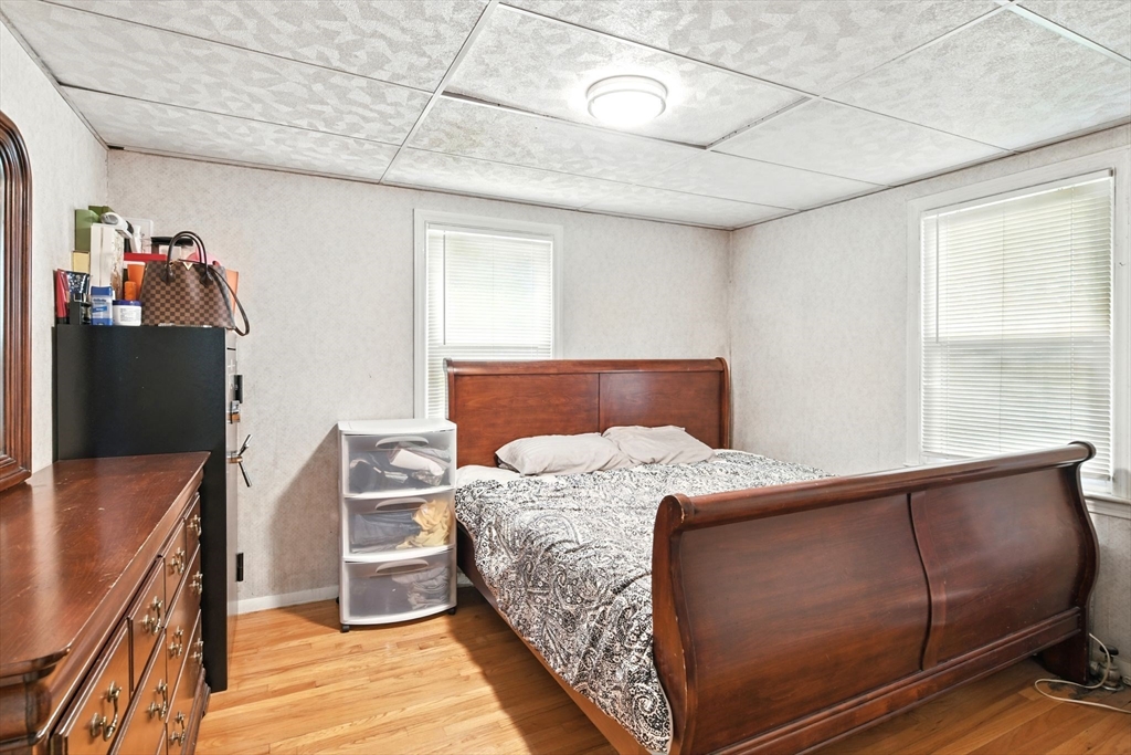 224 Cambria Street Springfield, MA 01118 - Photo 6 of 23 a bed sitting in a bedroom next to a window