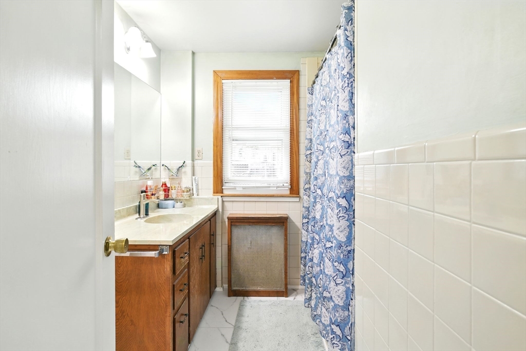 224 Cambria Street Springfield, MA 01118 - Photo 8 of 23 a bathroom with a sink and a mirror