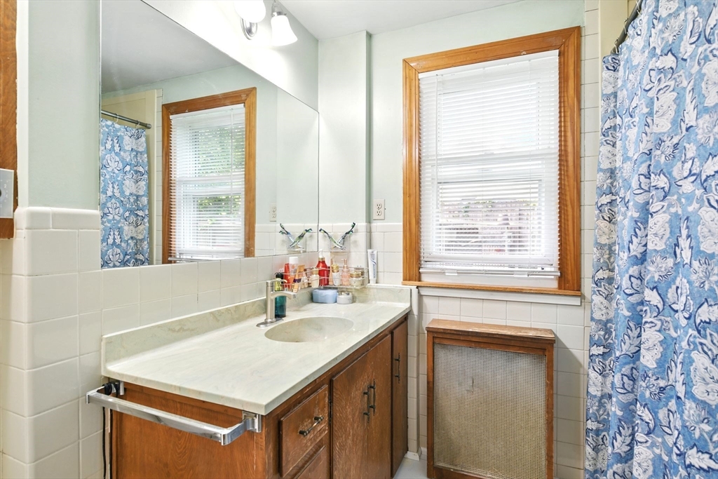 224 Cambria Street Springfield, MA 01118 - Photo 9 of 23 a bathroom with a sink double vanity and a bathtub