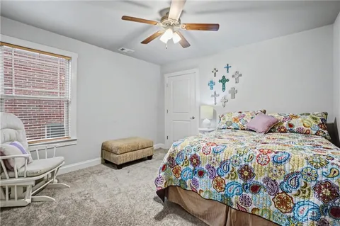 a bedroom with a bed and a chair