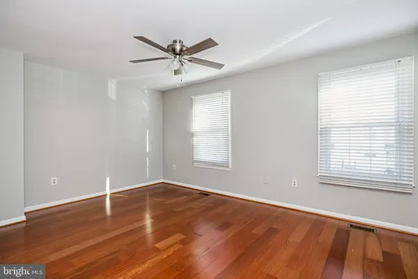 a view of a room with wooden floor and windows