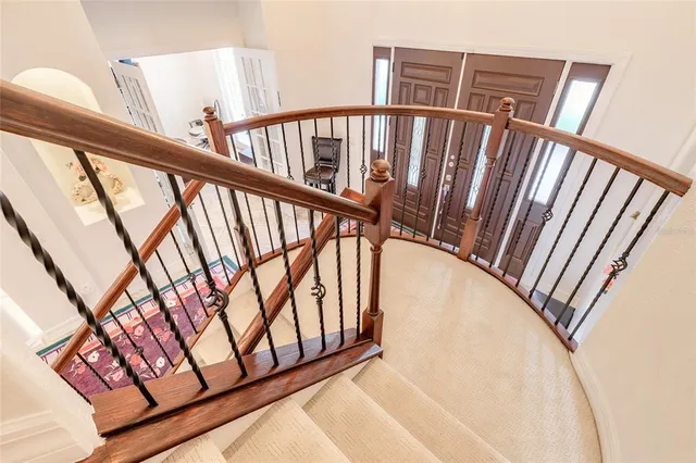 a view of staircase with railing and stairs