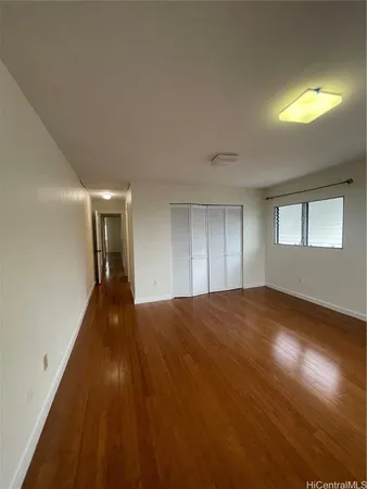 a view of empty room and wooden floor