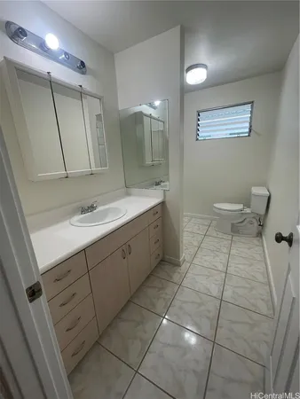 a bathroom with a sink a toilet and mirror