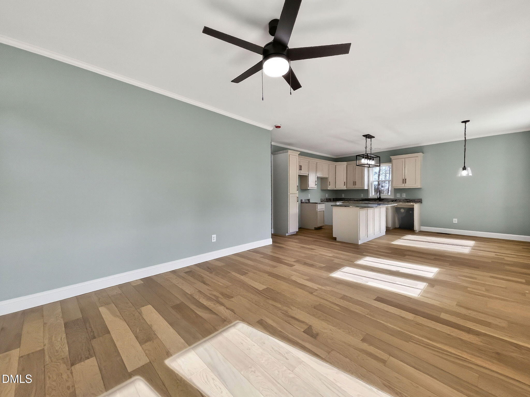 81 Pond View Court Rocky Mount, NC 27801 - Photo 12 of 28 a view of a kitchen with a dishwasher cabinets a ceiling fan and wooden floor