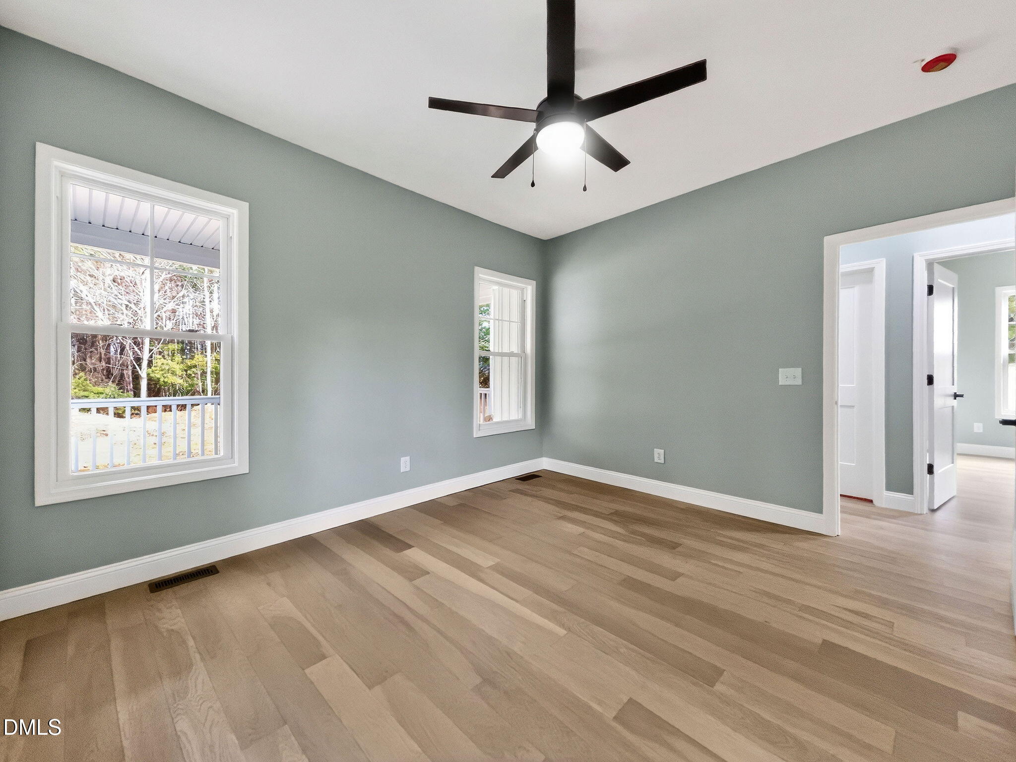 81 Pond View Court Rocky Mount, NC 27801 - Photo 23 of 28 an empty room with wooden floor chandelier fan and windows
