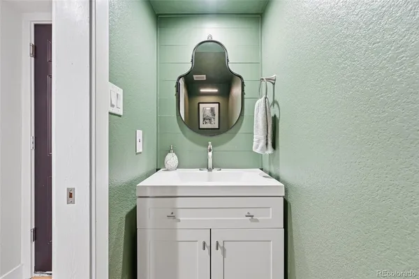 a bathroom with a toilet sink and mirror