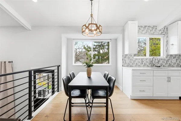 a dining room with furniture a window and a chandelier