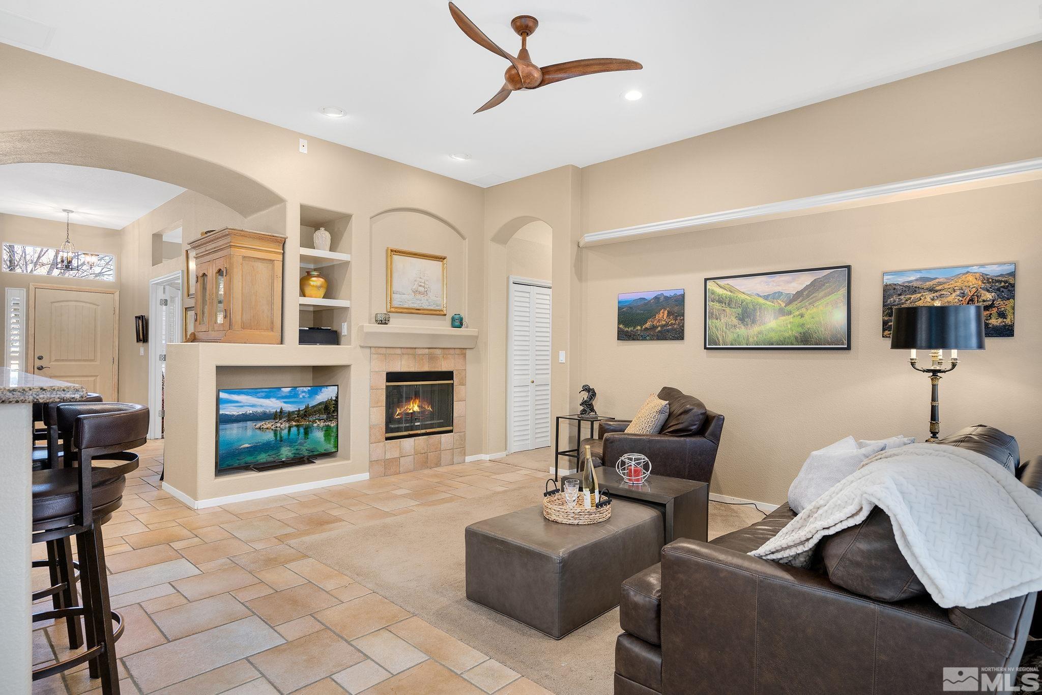 1700 Comanche Moon Drive Reno, NV 89521 - Photo 13 of 34 a living room with furniture a fireplace and a flat screen tv