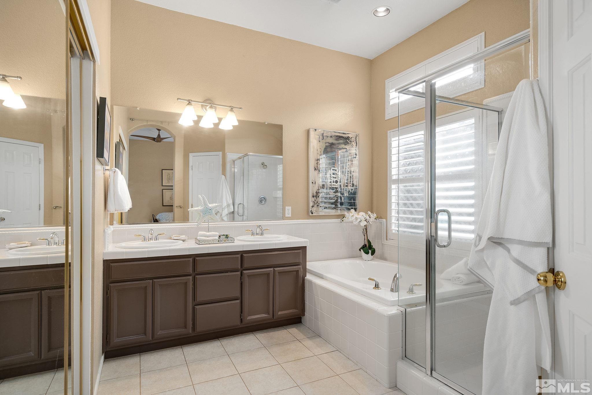 1700 Comanche Moon Drive Reno, NV 89521 - Photo 22 of 34 a bathroom with a tub sink and mirror