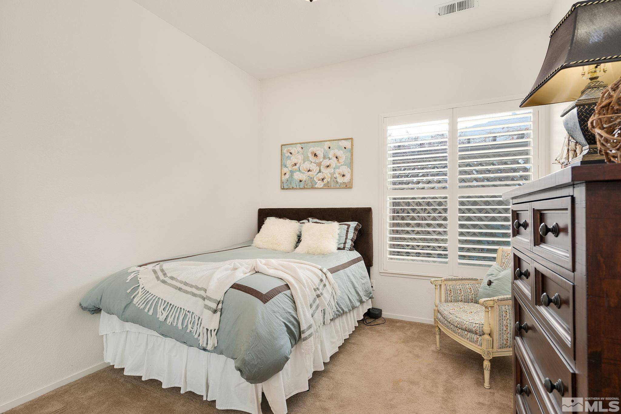 1700 Comanche Moon Drive Reno, NV 89521 - Photo 23 of 34 a bedroom with a bed and a large window