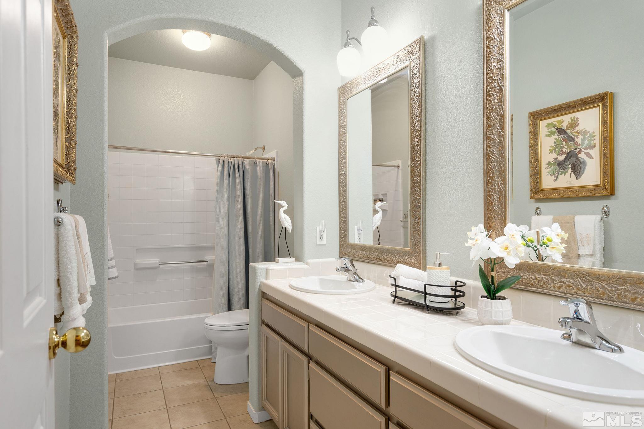1700 Comanche Moon Drive Reno, NV 89521 - Photo 24 of 34 a bathroom with a granite countertop sink toilet and shower