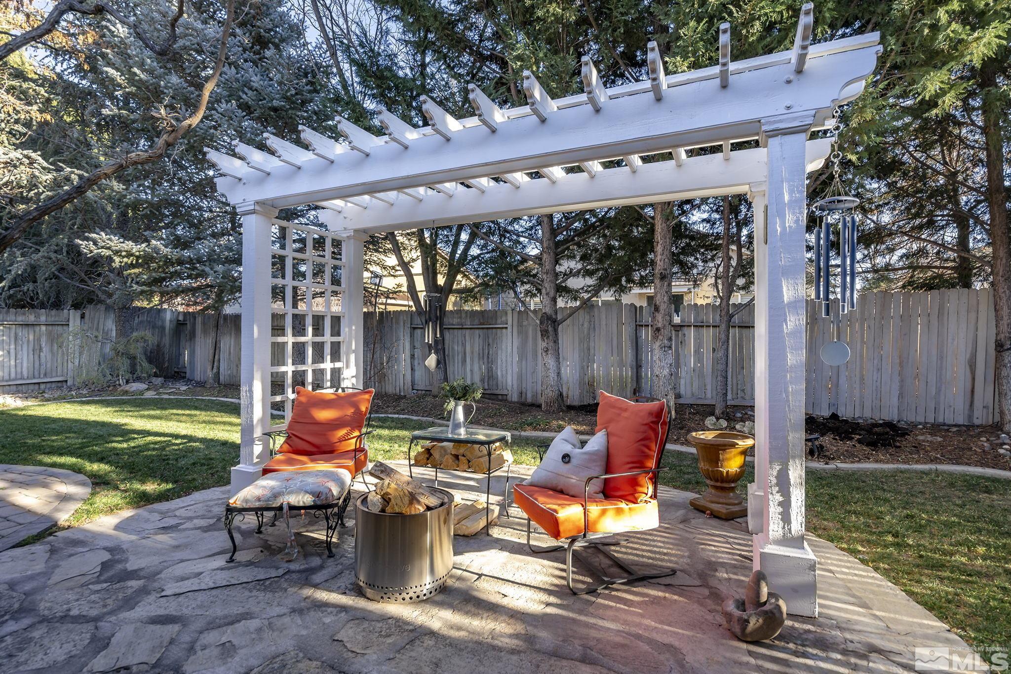 1700 Comanche Moon Drive Reno, NV 89521 - Photo 26 of 34 a view of a patio with table and chairs with wooden floor and fence