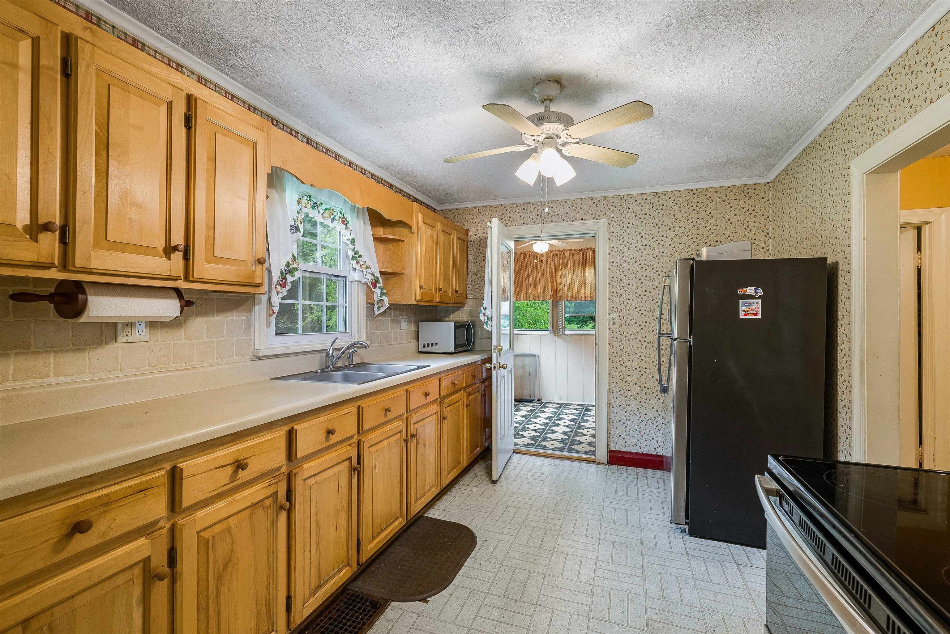 2156 Lyndhurst Road Waynesboro, VA 22980 - Photo 9 of 35 a large kitchen with kitchen island granite countertop a large window a sink and stainless steel appliances