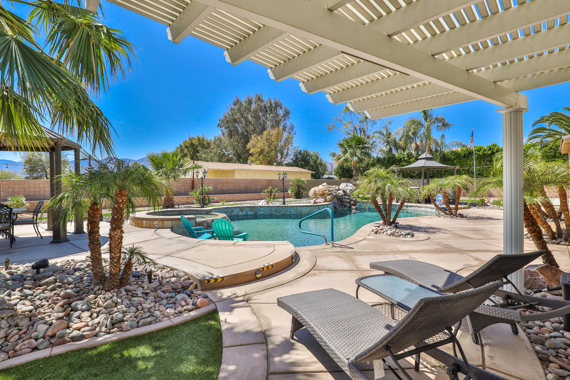 80445 Paria Way Indio, CA 92201 - Photo 1 of 70 a view of a patio with a table and chairs under an umbrella