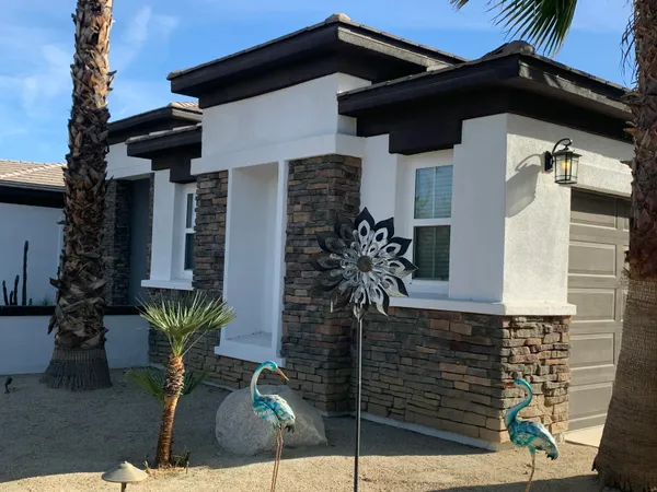 a front view of a house with garden