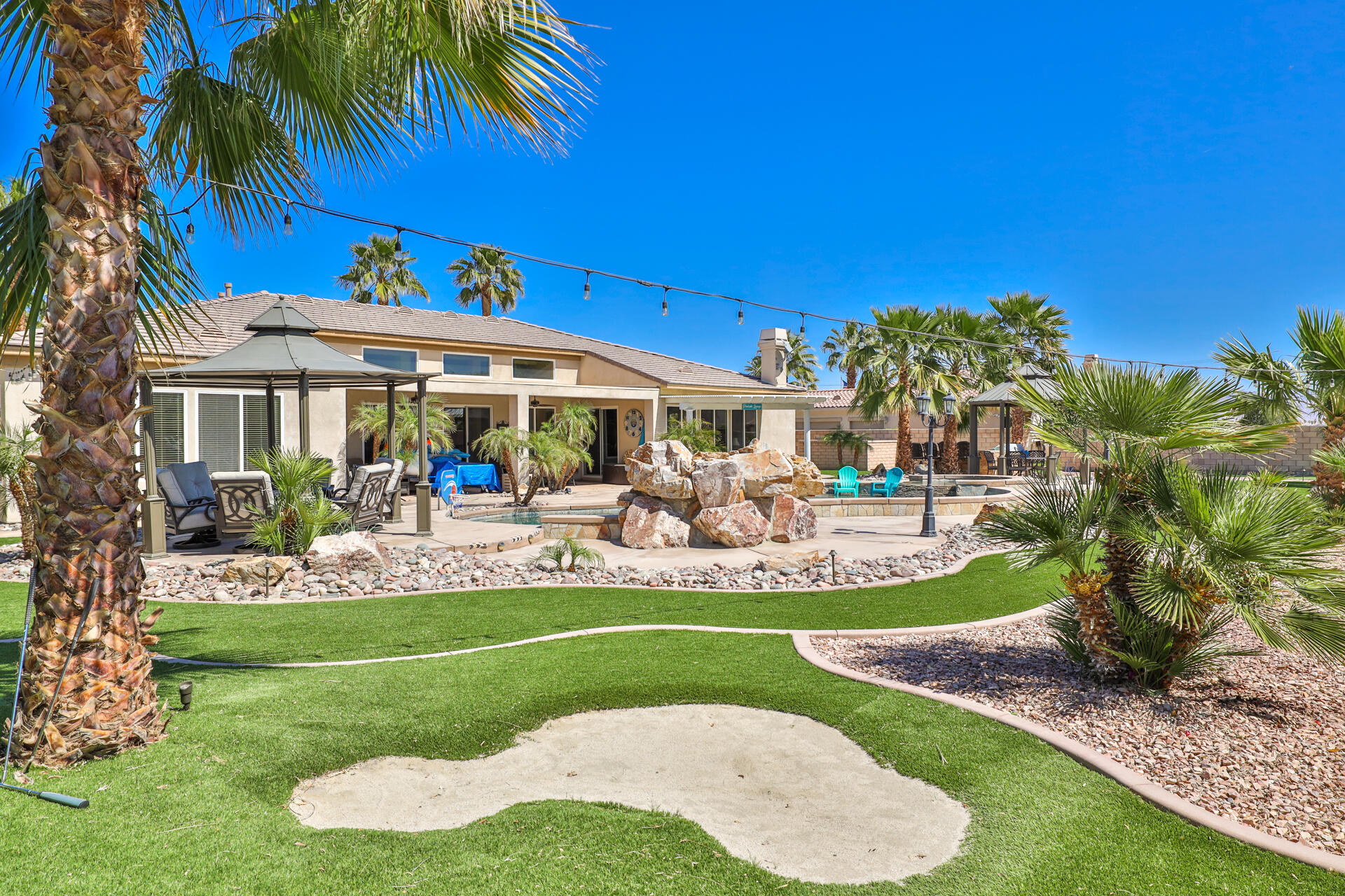80445 Paria Way Indio, CA 92201 - Photo 46 of 70 a front view of a house with garden and chairs