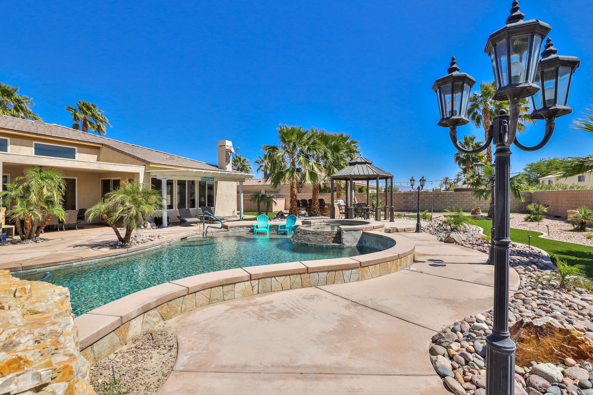 80445 Paria Way Indio, CA 92201 - Photo 51 of 70 a view of a house with backyard porch and sitting area