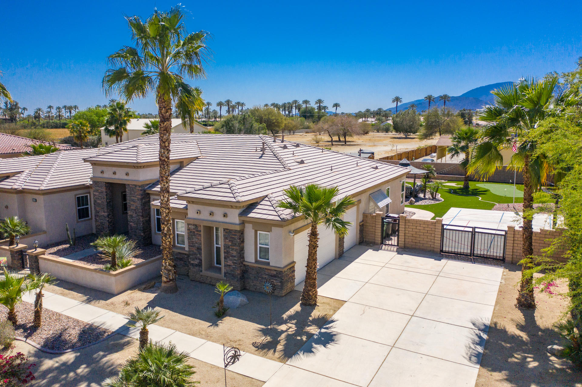 80445 Paria Way Indio, CA 92201 - Photo 57 of 70 a view of a patio with table and chairs potted plants with wooden floor and lake view