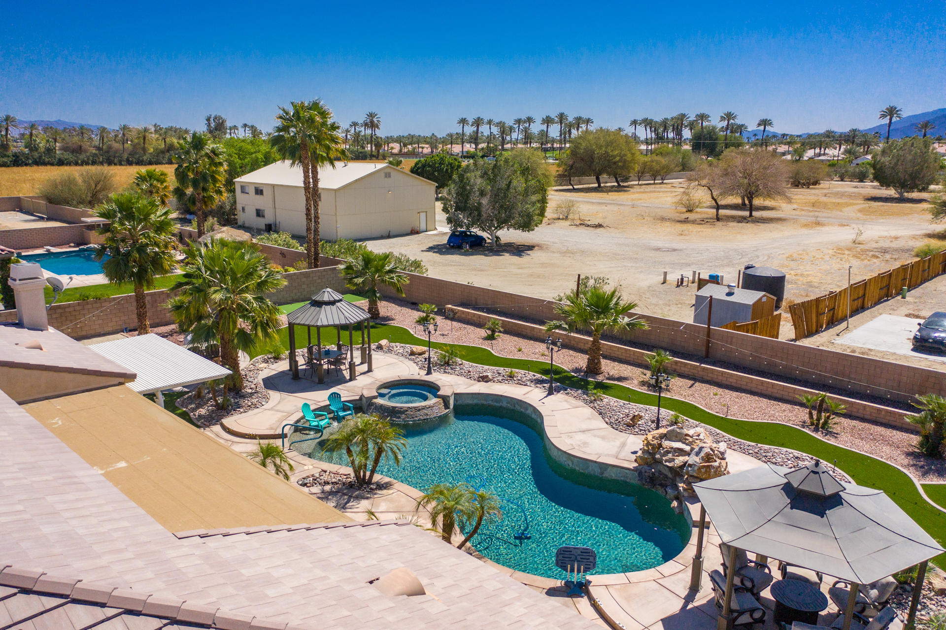 80445 Paria Way Indio, CA 92201 - Photo 59 of 70 a view of a swimming pool with a patio and a yard