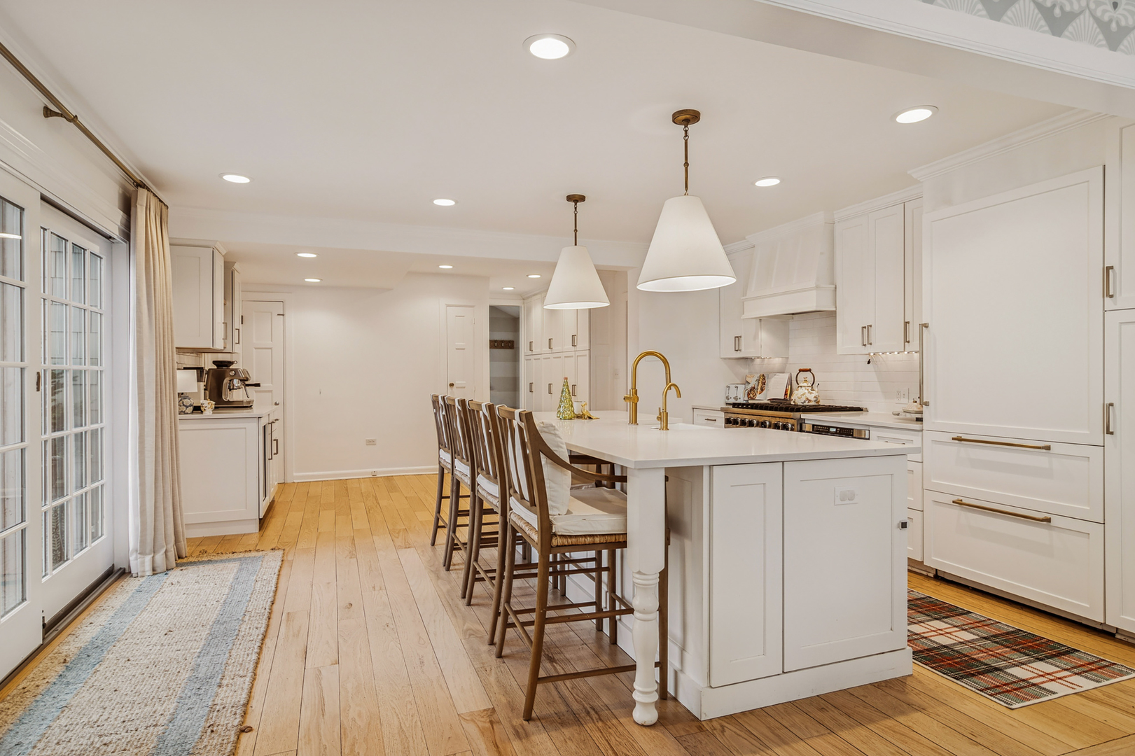 240 Elm Road Barrington, IL 60010 - Photo 14 of 56 a kitchen with stainless steel appliances kitchen island granite countertop a stove a sink a refrigerator and white cabinets with wooden floor