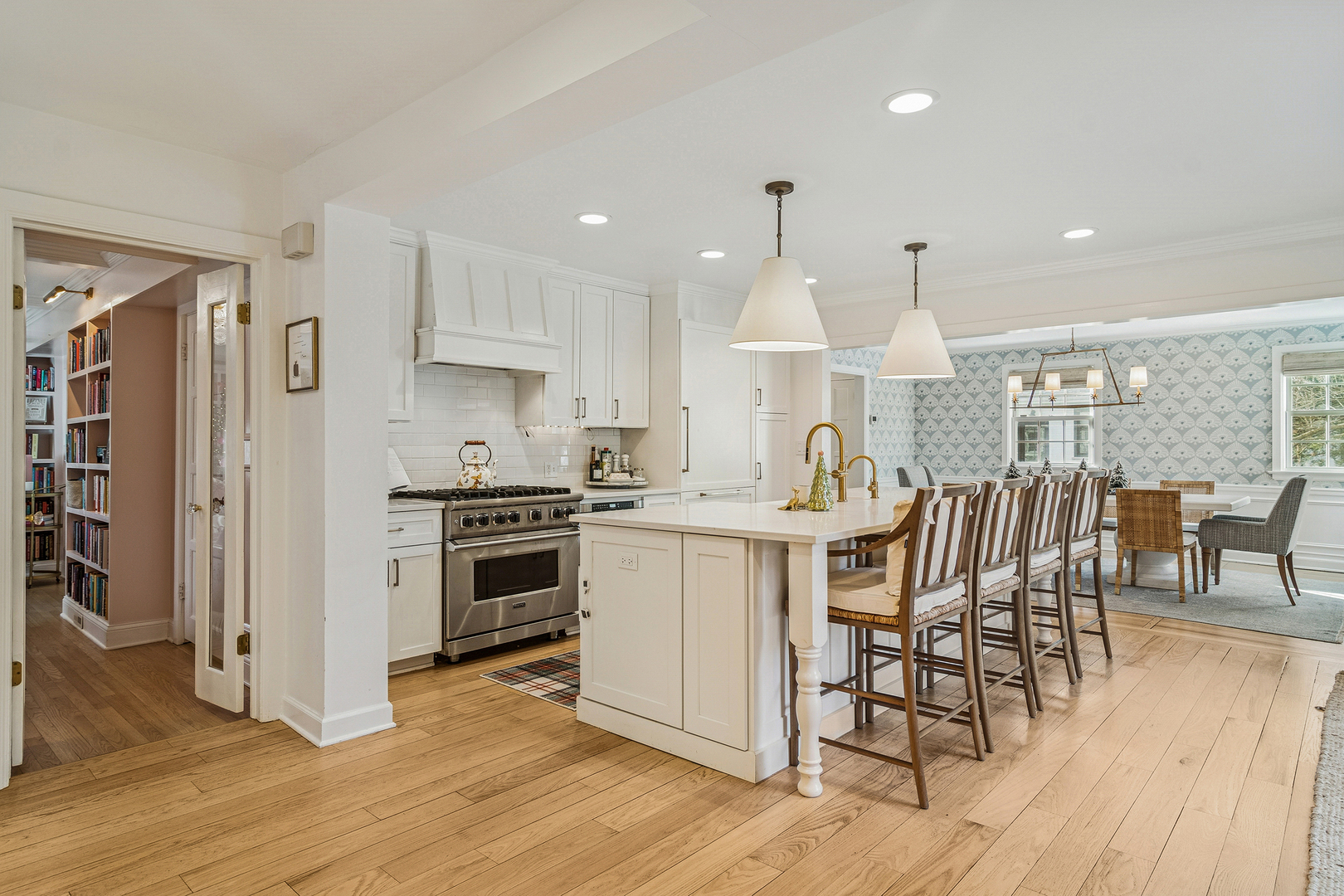 240 Elm Road Barrington, IL 60010 - Photo 19 of 56 a kitchen with stainless steel appliances kitchen island granite countertop a stove a sink a refrigerator and white cabinets with wooden floor