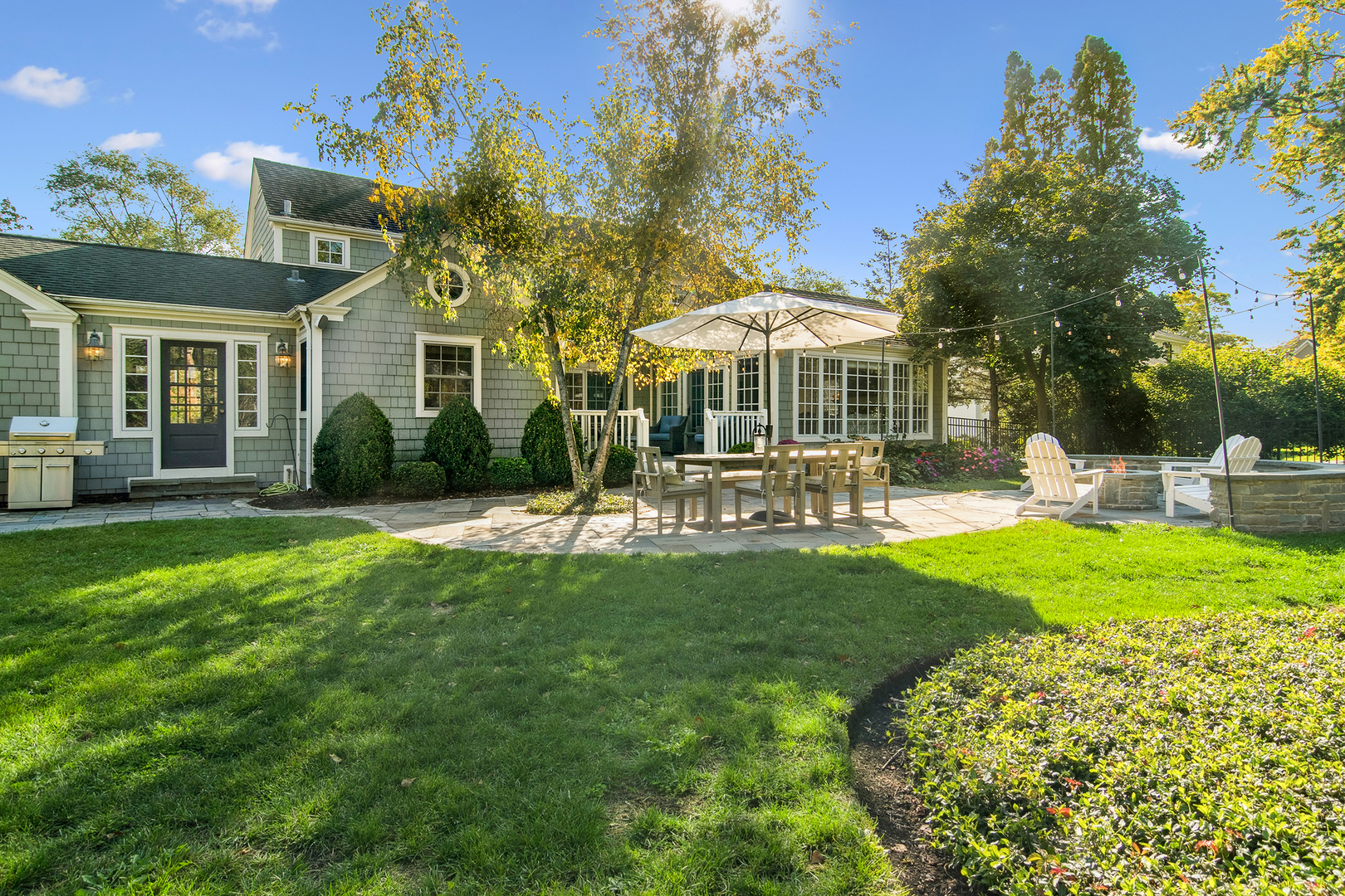 240 Elm Road Barrington, IL 60010 - Photo 53 of 56 a front view of a house with a yard table and chairs