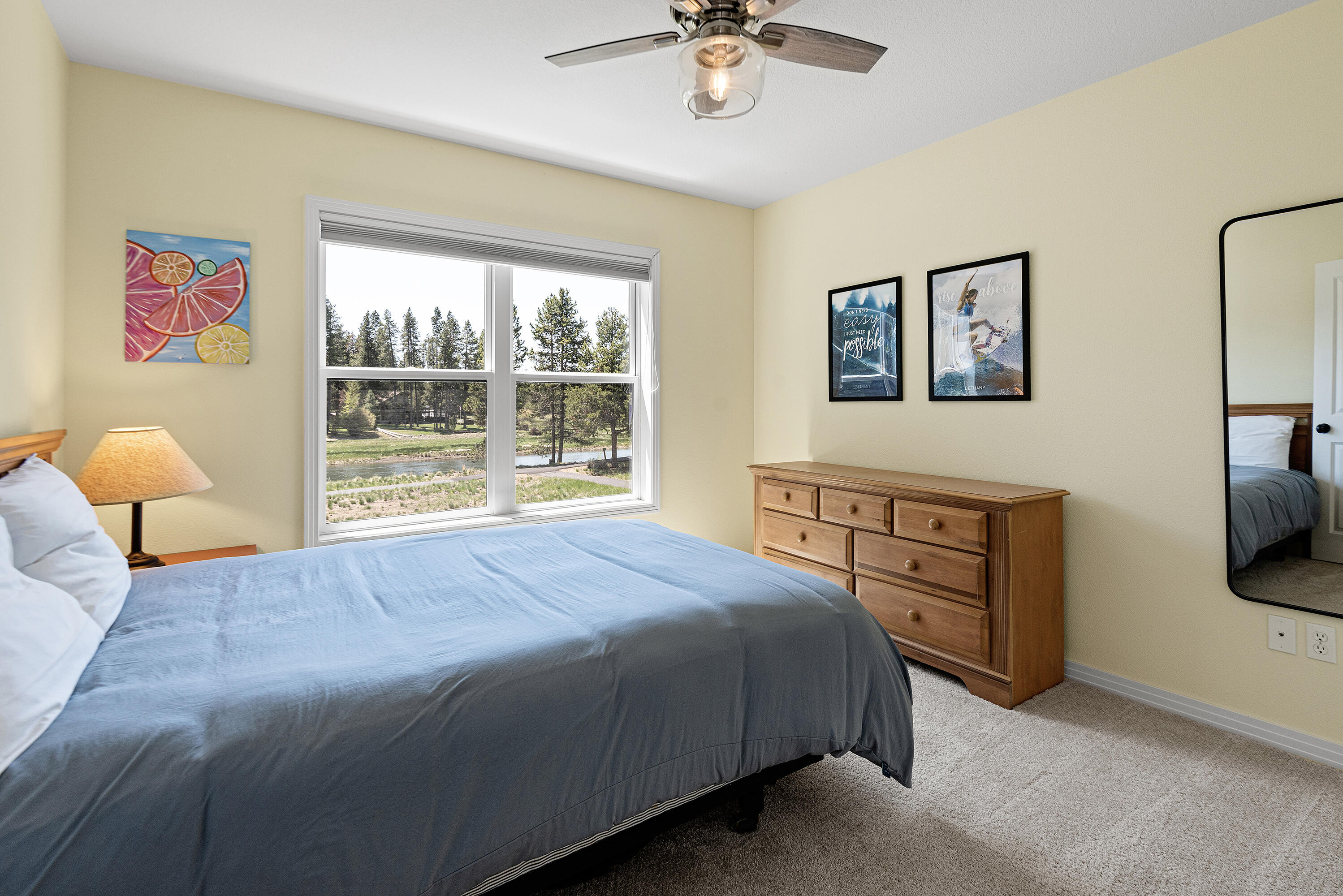 16775 Pony Express Way Bend, OR 97707 - Photo 17 of 38 a bedroom with a bed and a chandelier
