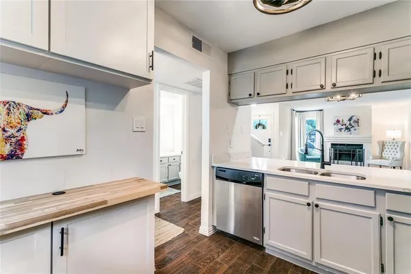 a kitchen with kitchen island white cabinets and refrigerator