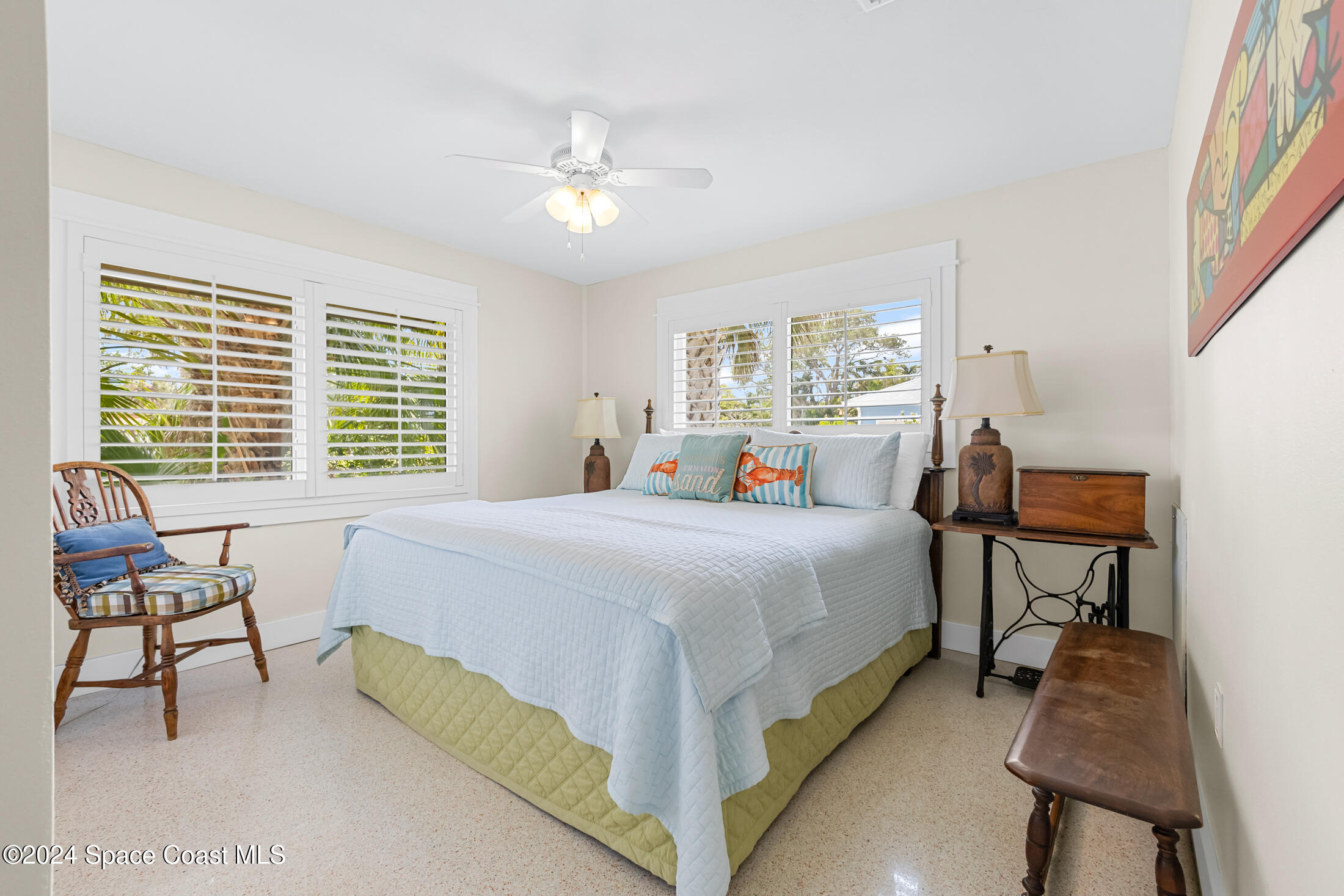 2051 Bali Road Cocoa Beach, FL 32931 - Photo 11 of 33 a bed room with a bed and a chair