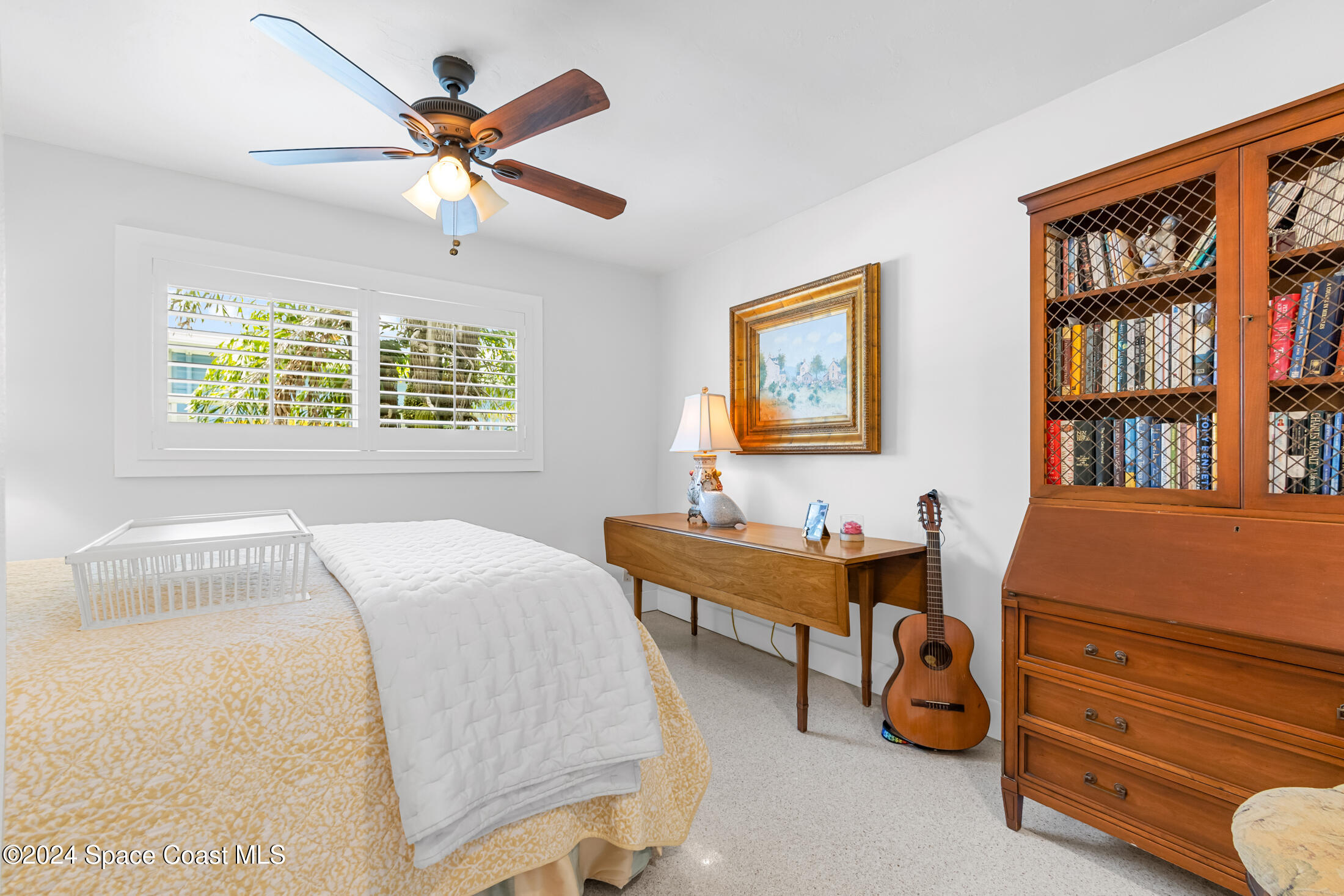 2051 Bali Road Cocoa Beach, FL 32931 - Photo 12 of 33 a bedroom with a bed and a desk
