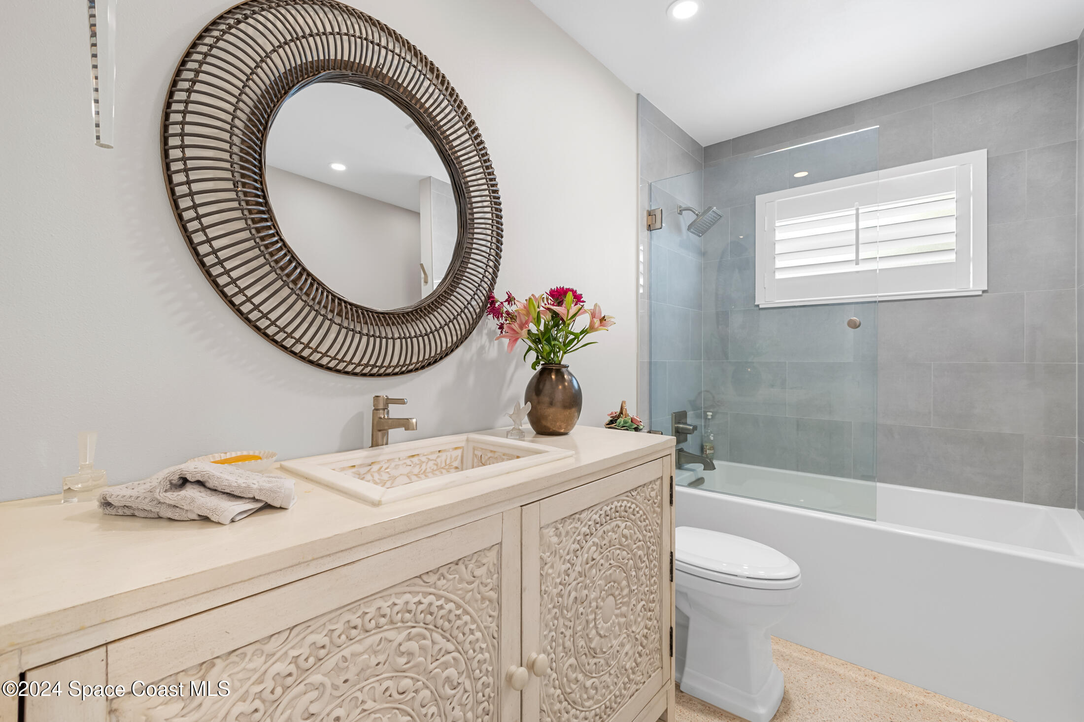 2051 Bali Road Cocoa Beach, FL 32931 - Photo 14 of 33 a bathroom with a sink a toilet and a mirror