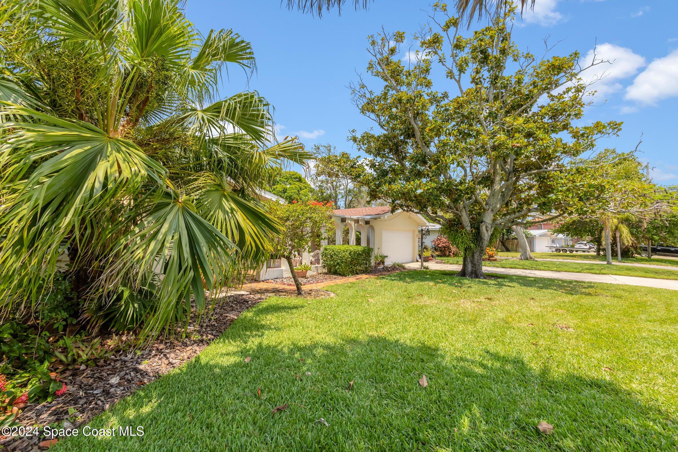 2051 Bali Road Cocoa Beach, FL 32931 - Photo 2 of 33 a backyard of a house with table and chairs