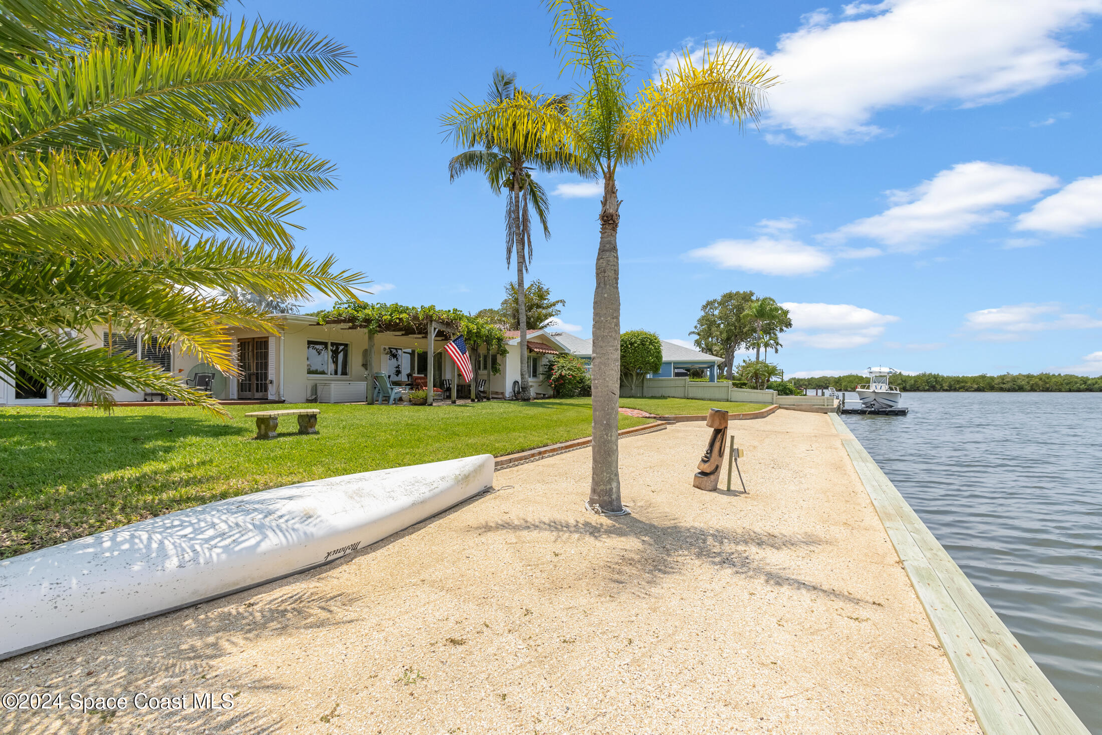 2051 Bali Road Cocoa Beach, FL 32931 - Photo 21 of 33 a view of a swimming pool with a yard