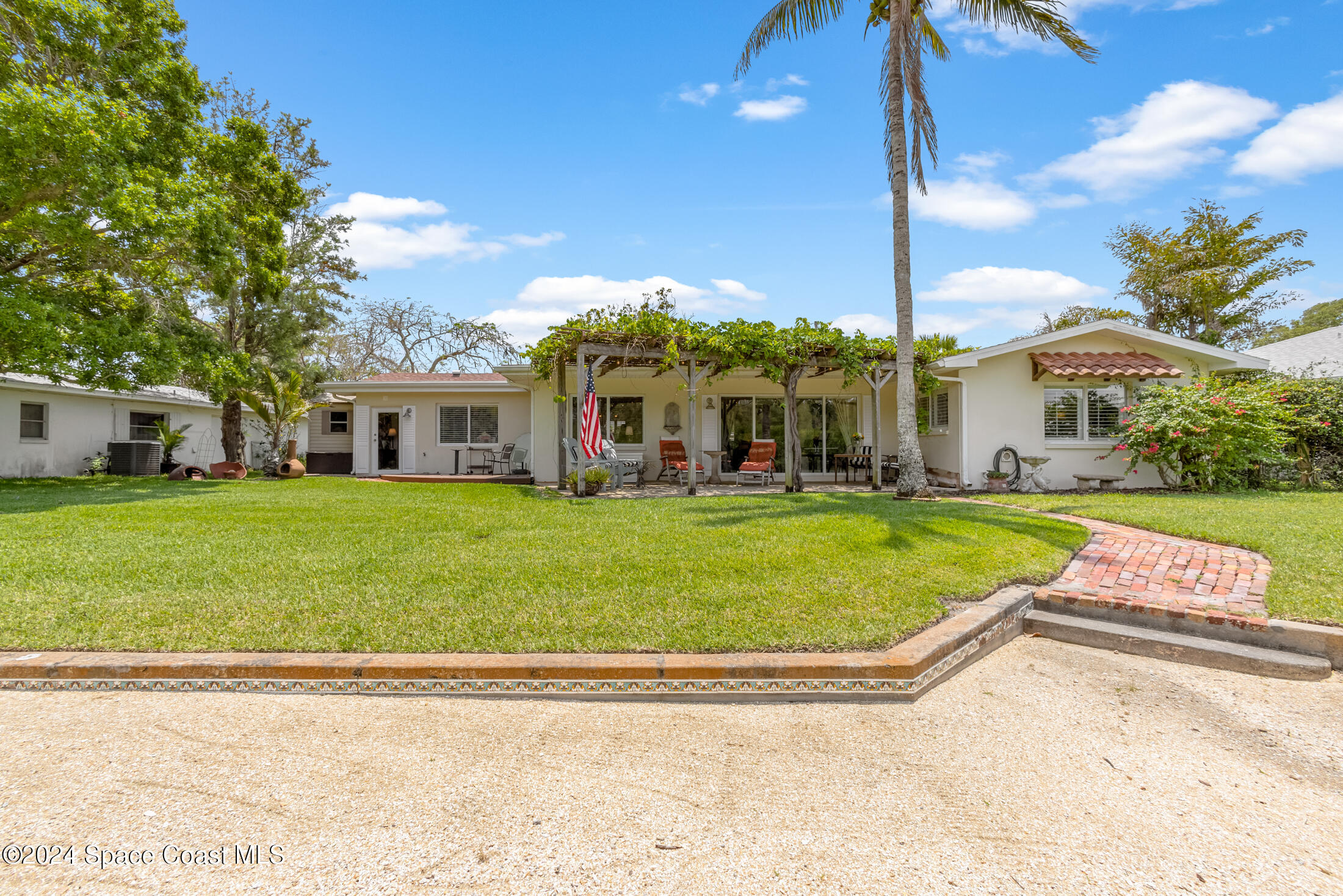2051 Bali Road Cocoa Beach, FL 32931 - Photo 22 of 33 a view of a house with a big yard