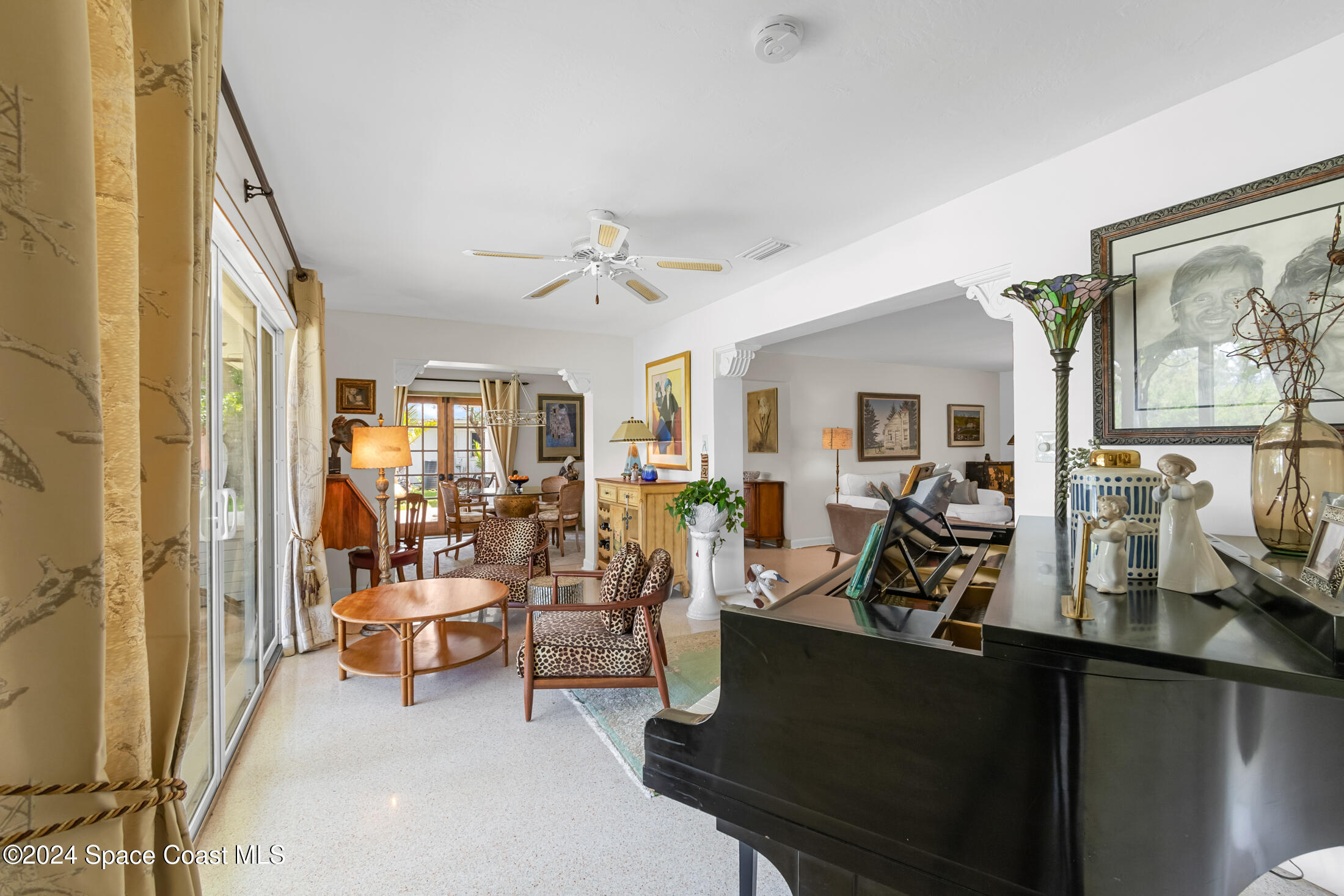 2051 Bali Road Cocoa Beach, FL 32931 - Photo 29 of 33 a view of a livingroom with furniture and a ceiling fan