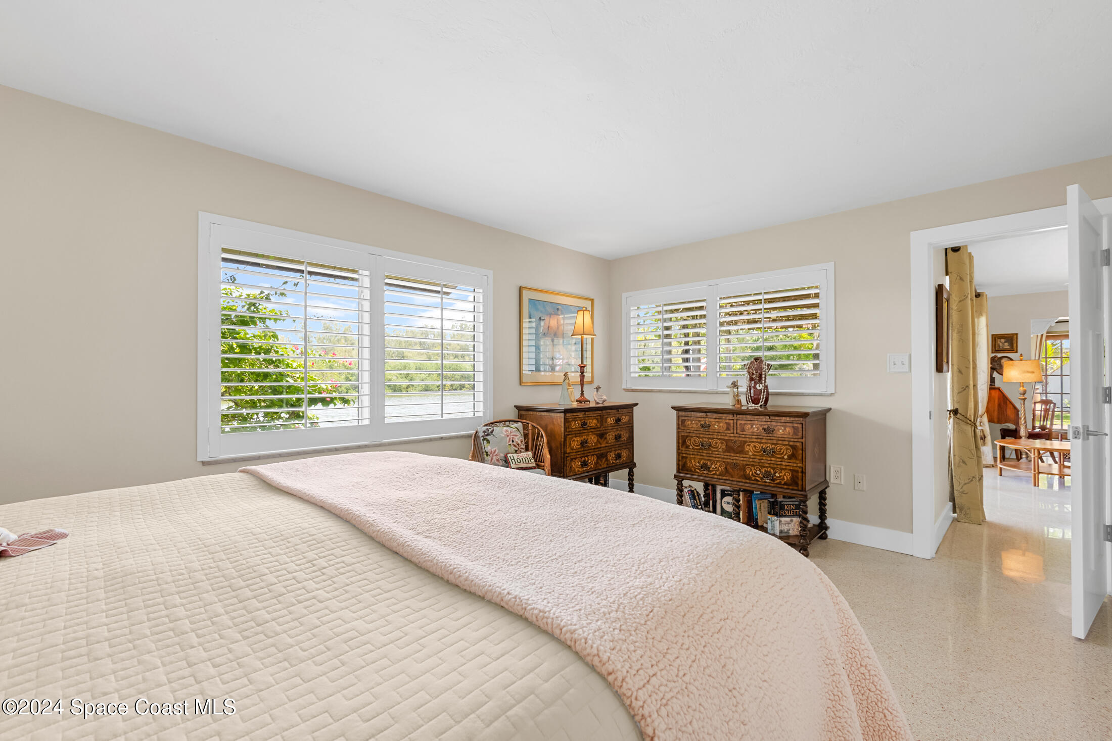 2051 Bali Road Cocoa Beach, FL 32931 - Photo 30 of 33 a large bedroom with a bed and wooden floor