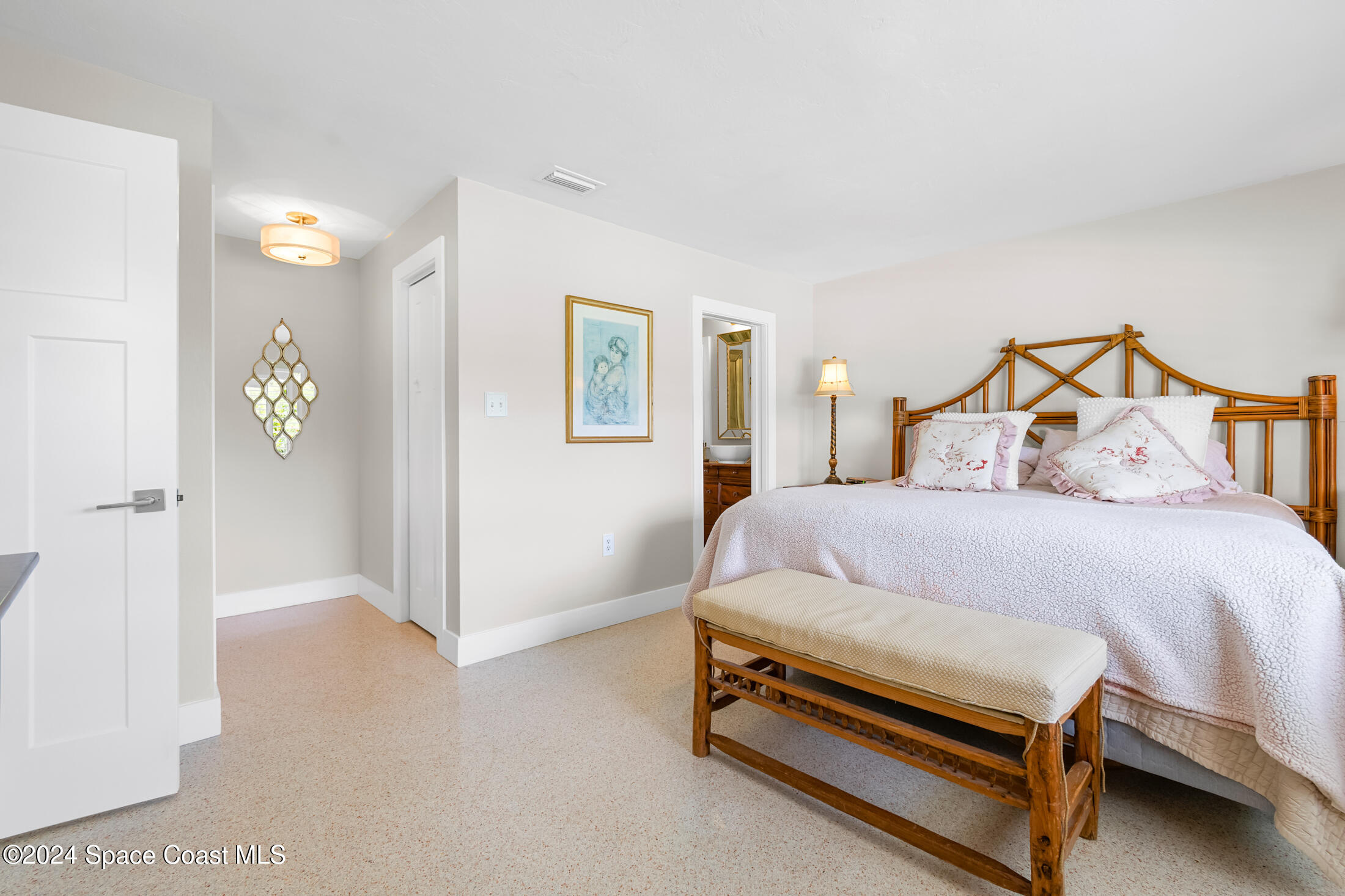 2051 Bali Road Cocoa Beach, FL 32931 - Photo 32 of 33 a bedroom with a bed and a night stand