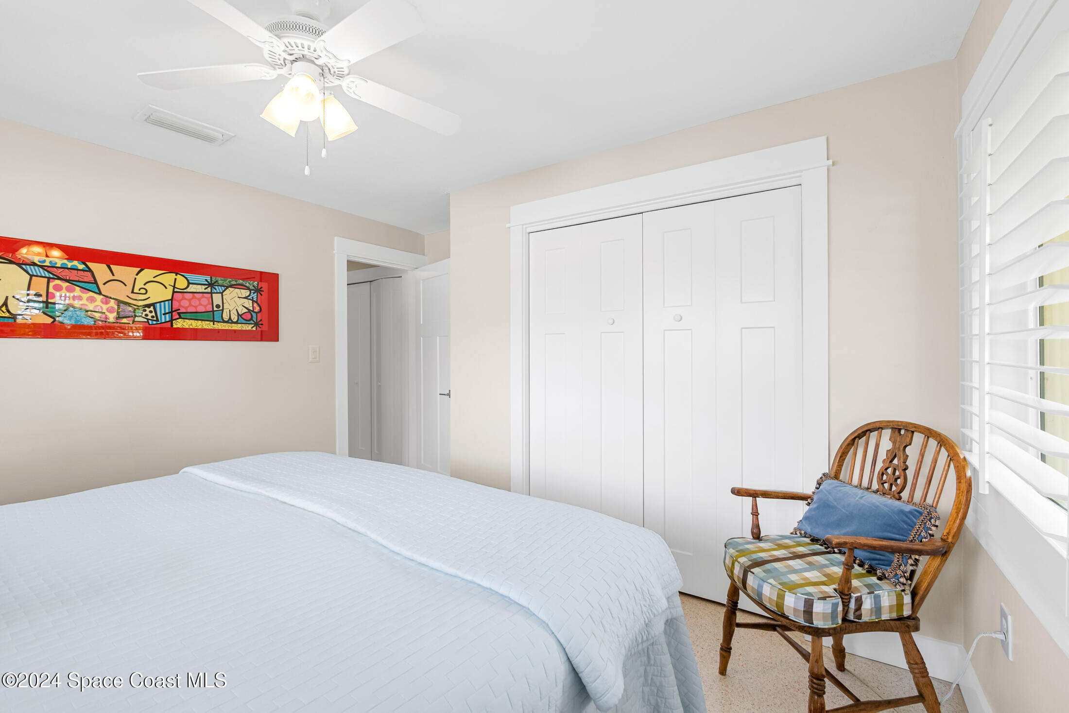 2051 Bali Road Cocoa Beach, FL 32931 - Photo 33 of 33 a bedroom with a bed and a chandelier
