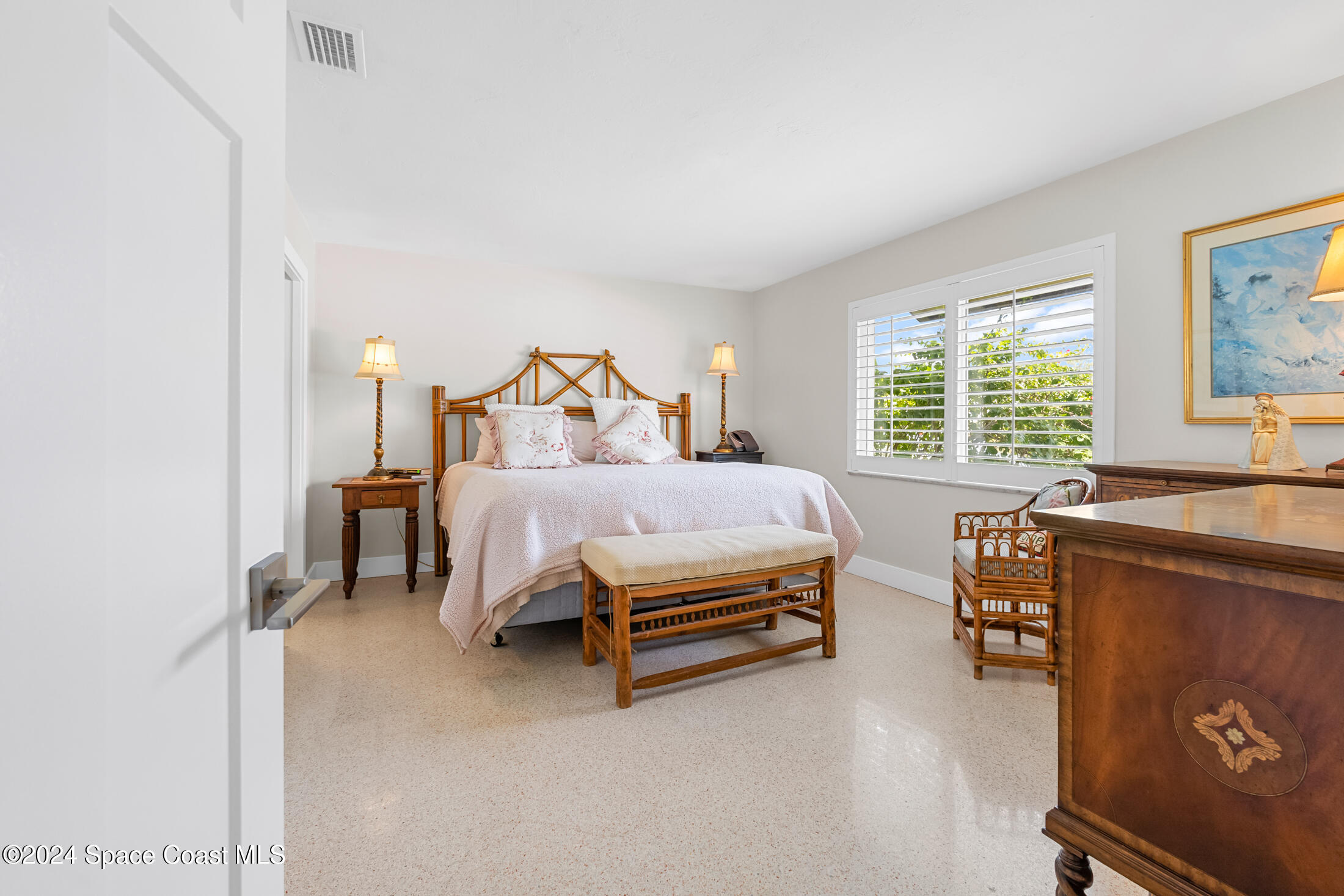 2051 Bali Road Cocoa Beach, FL 32931 - Photo 8 of 33 a bedroom with a bed and a window
