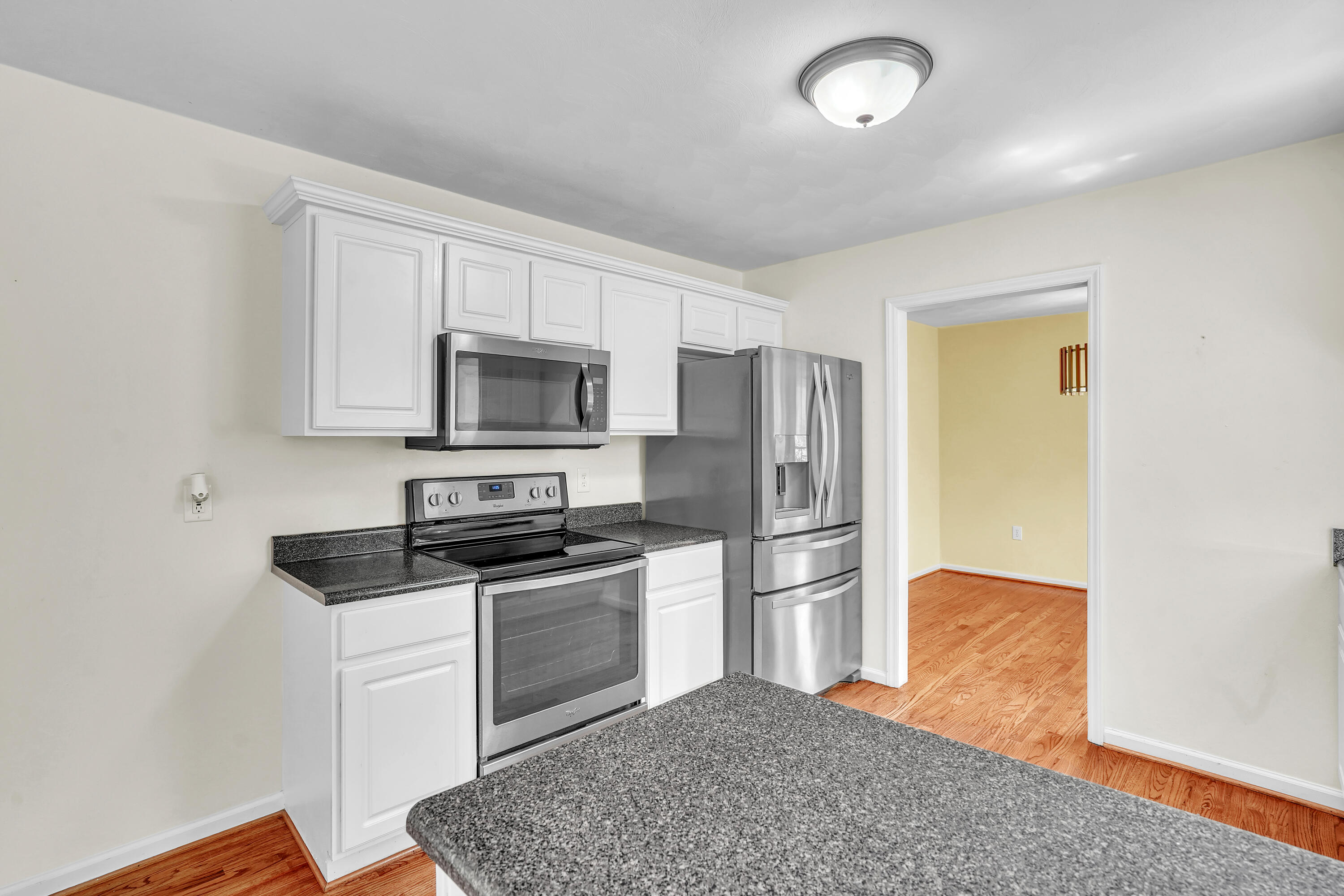7607 Peebles Lane Roanoke, VA 24018 - Photo 15 of 57 a kitchen with granite countertop a refrigerator and a stove top oven