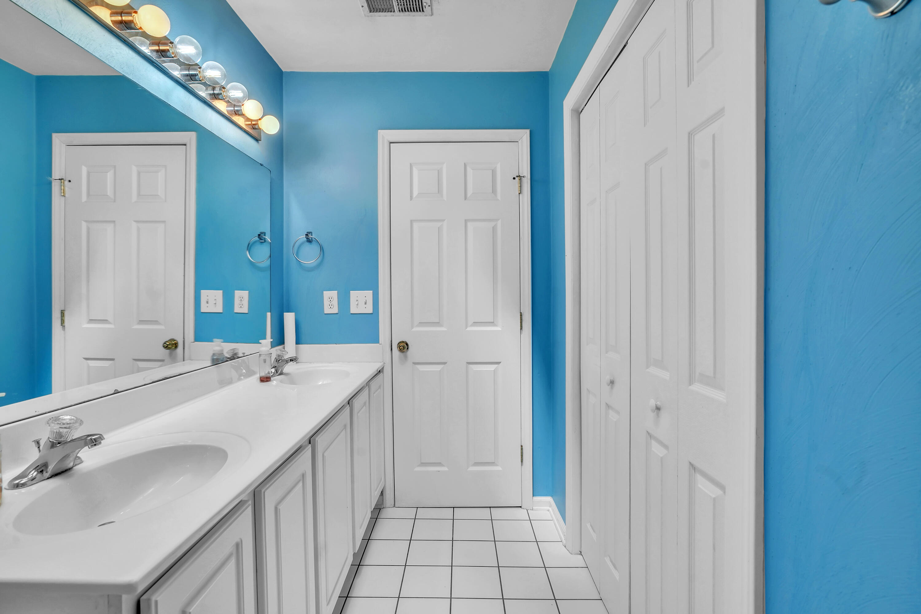 7607 Peebles Lane Roanoke, VA 24018 - Photo 30 of 57 a bathroom with a double vanity sink and a mirror