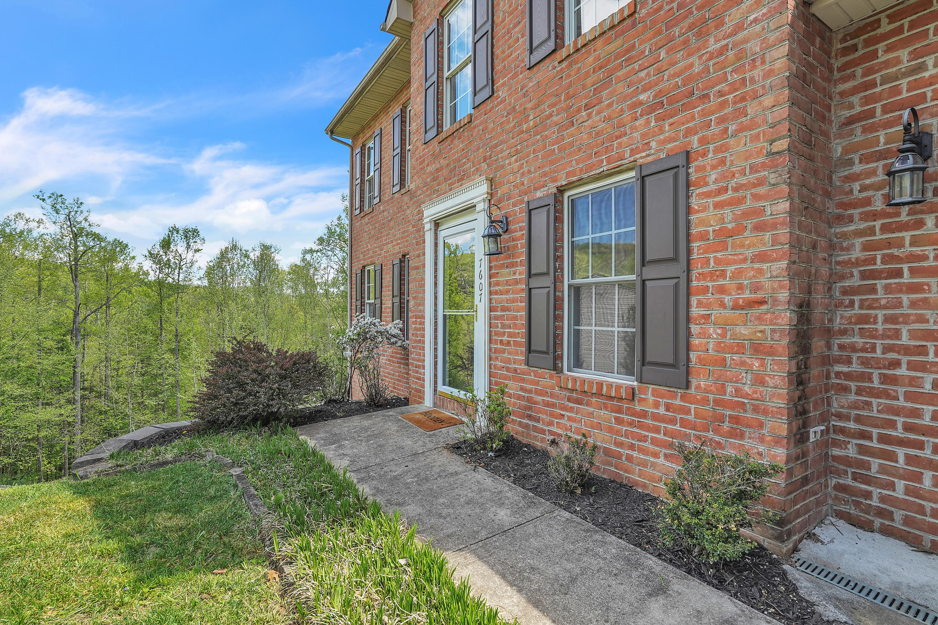 7607 Peebles Lane Roanoke, VA 24018 - Photo 5 of 57 a view of a brick house with a yard