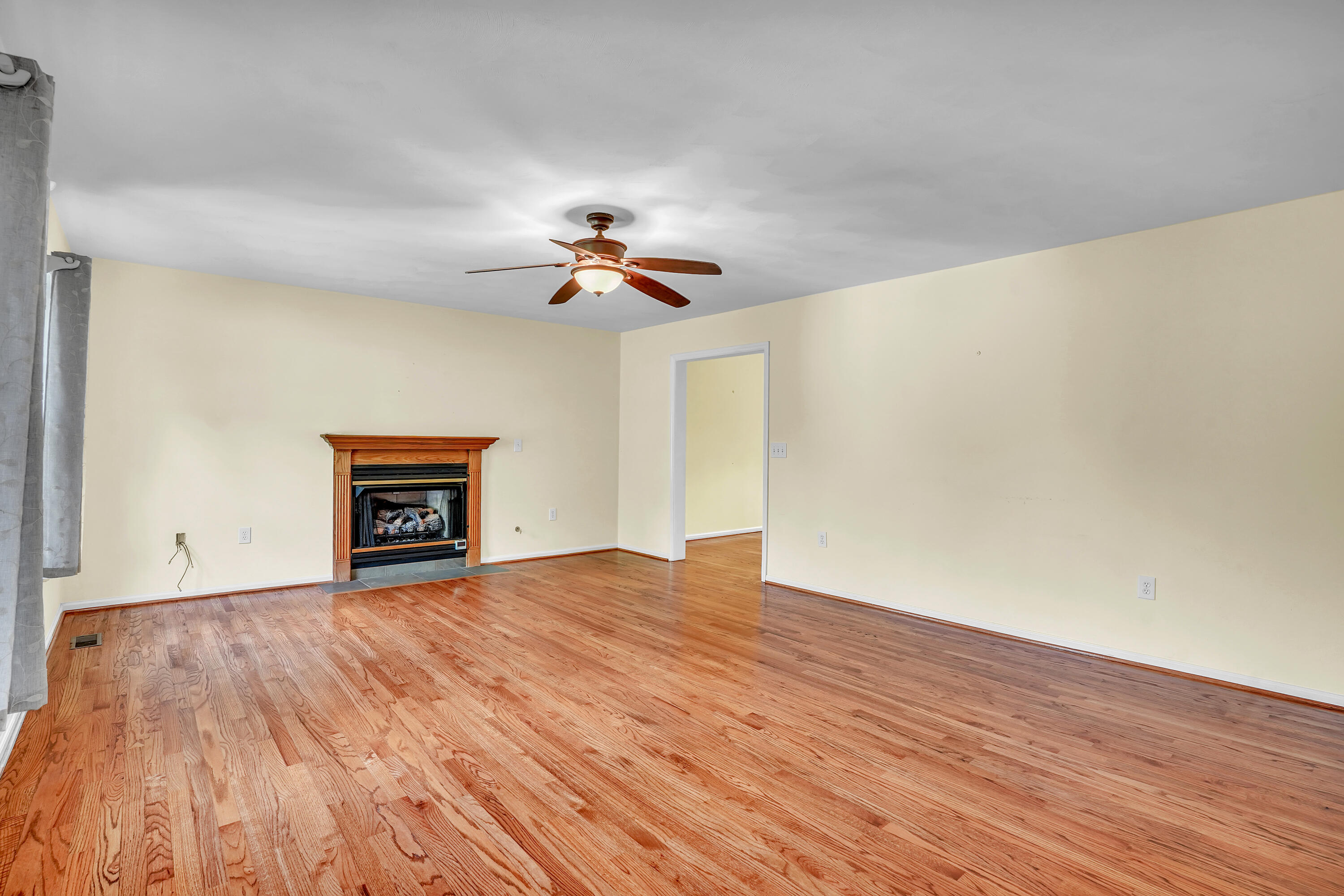 7607 Peebles Lane Roanoke, VA 24018 - Photo 6 of 57 a view of an empty room with a window and wooden floor