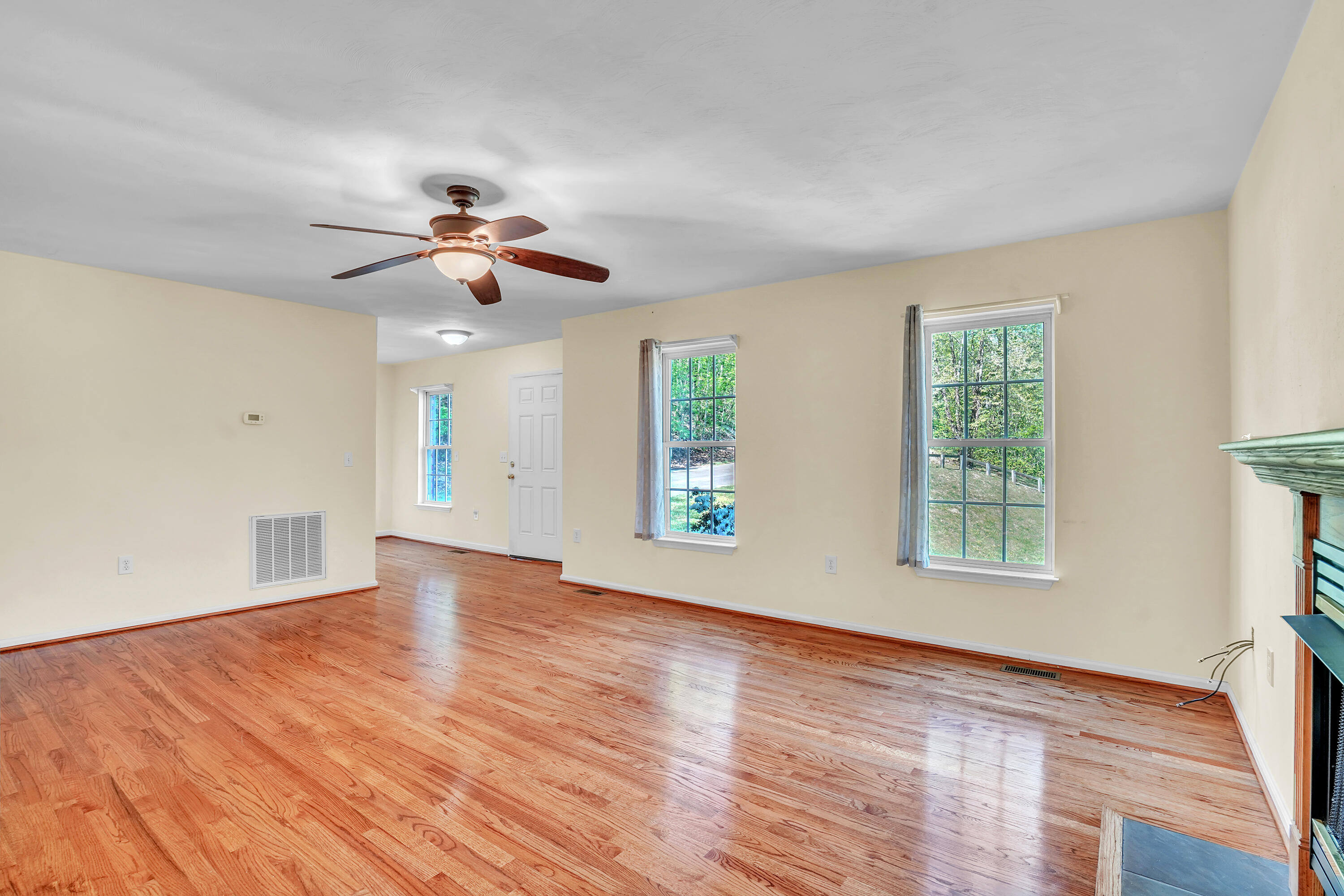 7607 Peebles Lane Roanoke, VA 24018 - Photo 8 of 57 a view of an empty room with a window and wooden floor