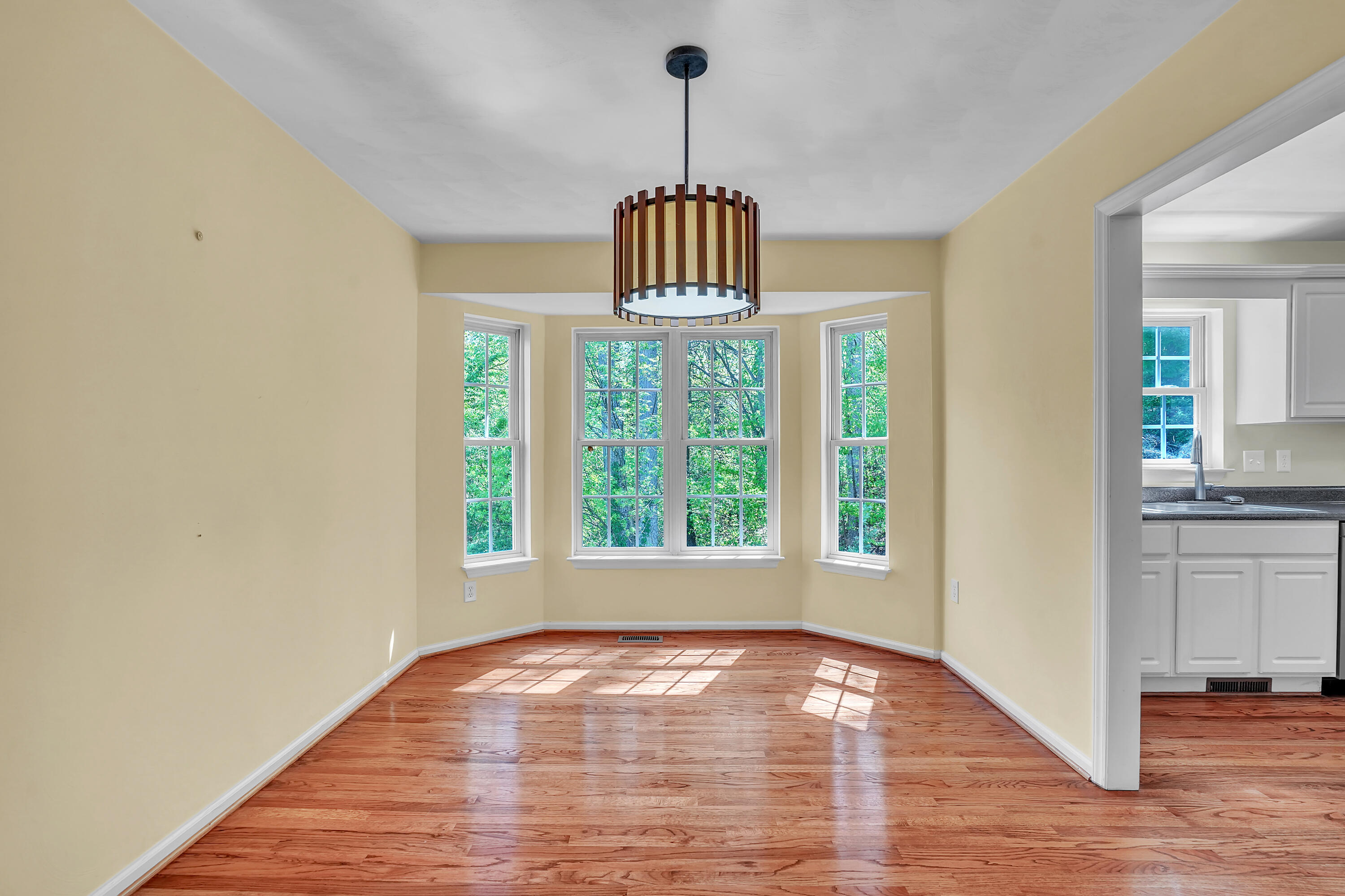 7607 Peebles Lane Roanoke, VA 24018 - Photo 9 of 57 a view of an empty room with window and wooden floor