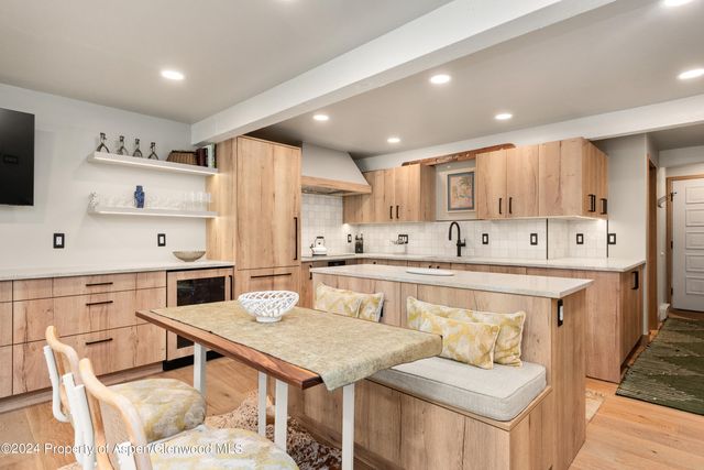 a kitchen with stainless steel appliances kitchen island granite countertop a sink and cabinets