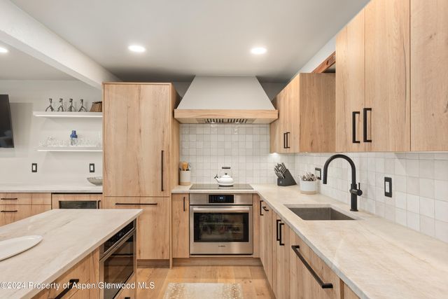a kitchen with a stove a sink and a refrigerator