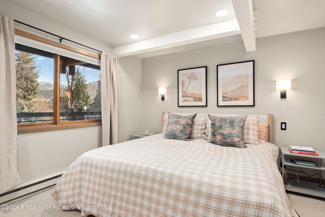 a bedroom with a large bed and a large window