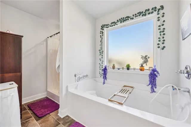 a bathroom with a tub sink and a mirror